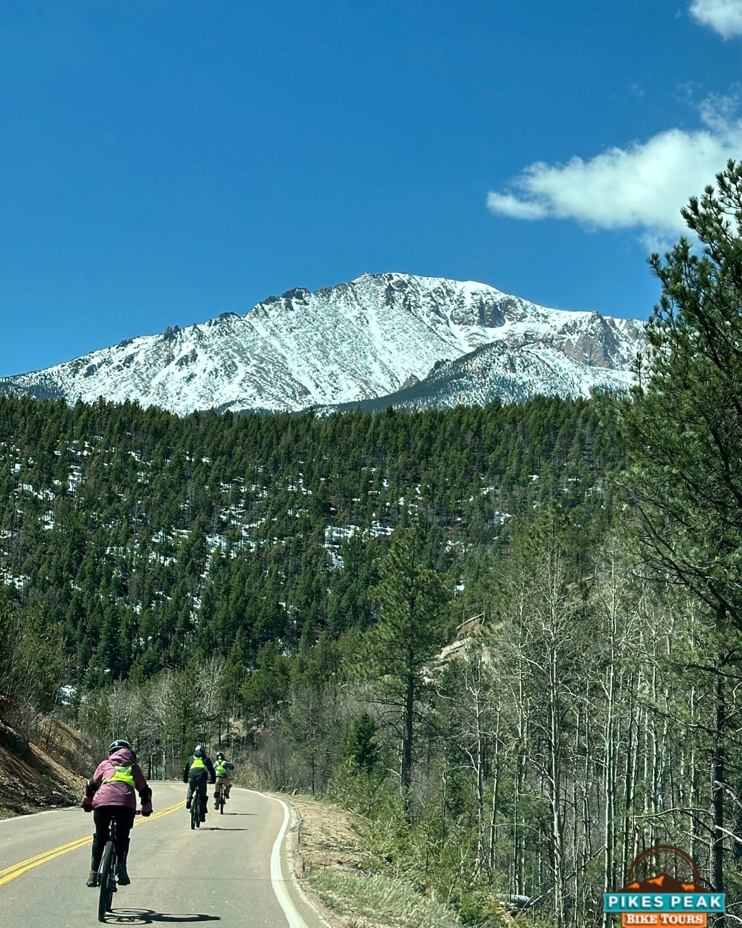 Cyclists at Pikes Peak summit with Trek bikes before downhill ride Colorado Springs