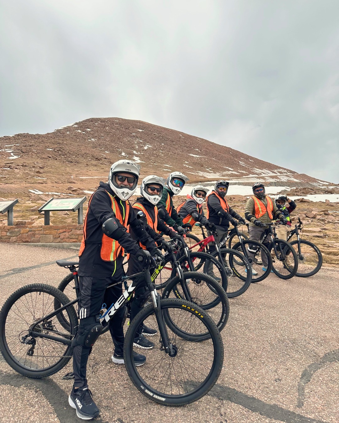 Guided downhill bike tour group at Pikes Peak summit Colorado Springs